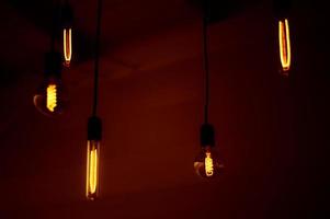Group of tungsten light bulbs in the dark. photo
