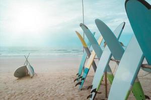 Many surfboards for rent  at summer beach with sunlight  blue sky. photo