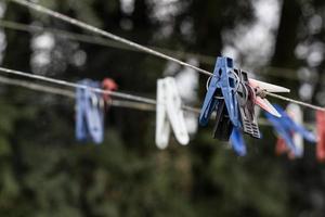 Clotheslines with plastic clothespins of different colors. A device for drying laundry on the street. Living in a private home photo