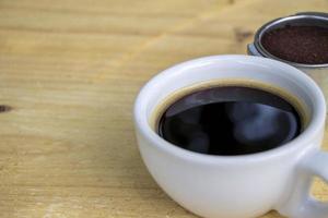 cup of coffee on wooden table photo