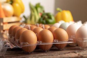 eggs of chicken and duck in plastic box placed on a wooden table photo