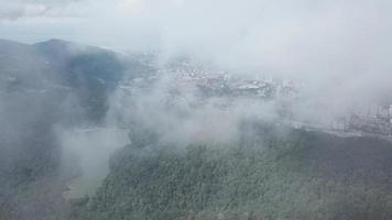 Aerial fly over foggy sky above Ayer Itam dam and Georgetown, Penang. video