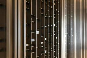 Random battens steel and pole are set in front of hotel wallpaper for backdrop and background. photo