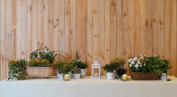 flowers decorate on the dinning long table in the luxury relax event with the wood plate background. photo