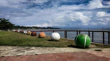 Pasangkayu, West Sulawesi, Indonesia, 2022 - Miniatures of various types of balls such as soccer balls, basketballs, volleyballs and others on the beach of Anjungan Vovasanggayu in  Pasangkayu photo