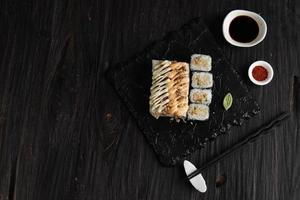 Mentai Sushi, Philadephia Roll, and Beef Floss Roll Mayo Roll, Various Makizushi on Stone Plate. Top View with Copy Space for Text photo