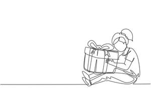 Continuous one line drawing cheerful girl sitting and hugging big gift box with ribbon bow wrapped in front of her in arms. Little kid accept birthday gift. Single line draw design vector illustration