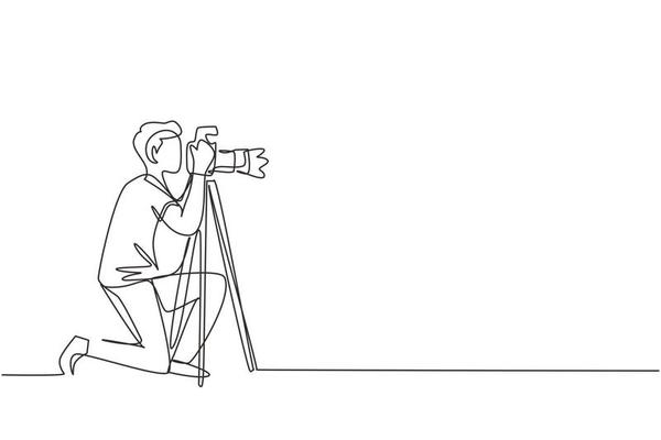 Single continuous line drawing professional photographer man kneeling for taking pictures with digital camera and tripod. Digital photography hobby. One line draw graphic design vector illustration