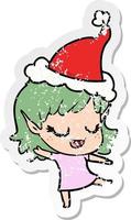 happy distressed sticker cartoon of a elf girl wearing santa hat vector