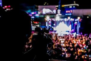 silhouette videographer had been recorded to blurred and bokeh countdown concert., Bangkok, Thailand. photo