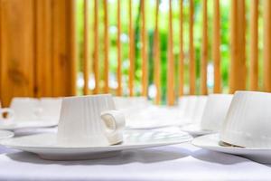 Emptry cup of tree arranged on table with wood barttens background photo