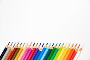 blunt colour pencils are arranged in the line on the white background and ready to paint. photo