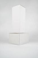 White two paper boxes - tall and fat lay on the white background in studio shot with clipping paht. photo