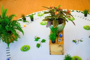 Candle decoration on the wood floow with flower fern and tree on white circle in the middle of woodfloor center inside the hall. photo