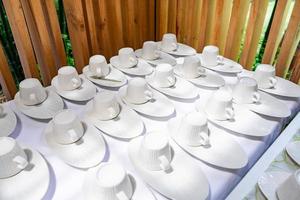 Emptry cup of tree arranged on table with wood barttens background photo