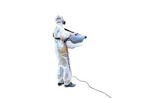 Professional technical man in prevention suit sprays sterilising solution by elctrical spray machine on wood floor and white background with stuido light. photo