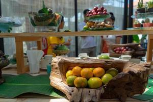 Variety fruits such as rambutan orange mangosteen red plum on the wood counter bar for seminar pepole in outdoor at garden in Thailand. photo