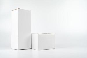 White two paper boxes - tall and fat lay on the white background in studio shot with clipping paht. photo