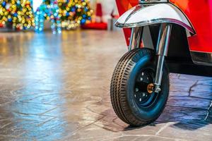 Closeup focus concept on new TukTuk Thailand traditional car, front of tire wheel. With colourful bokeh background. photo