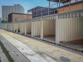 Reused Container construction budilding in the row beside footpath. photo