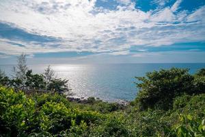 The tree is foreground in front of seascape and horizontal line with open clear sky and cloud. This place is Koh Kood Thailand. photo