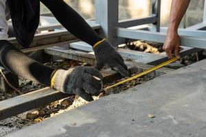 Workers are measuring the floor of toilet before construct and process next step photo