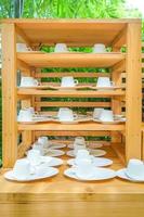 wood shelf in outdoor graden with a lot of coffee cup on it. photo