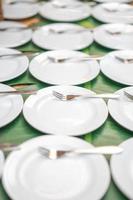 Samll white dish are arranged in the grid line with little fork on it, prepare for seminar breaking time. photo