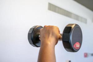 close up to black dumbbell in indoor fitness room., Thailand. photo