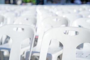 close up white chair back in the row in Thailand event at outdoor park. photo