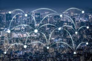 Business Network Connection laser beam and center accessing point on Aerial cityscape view high building at the night. Clipping path. photo