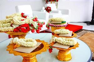 Garland on the Phan Thai traditional up step dish on the table and letter card, prepare for ceremony and event. photo