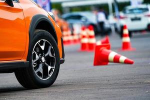 close up wheel of orange car on the road photo