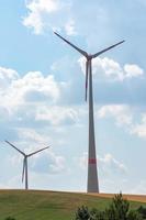 Wind turbines in farmland supplying green energy photo