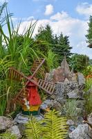 a decorative little windmill in a garden photo