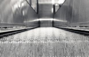 escalator in black and white shot photo