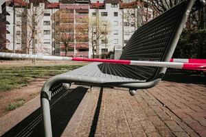 a restricted zone due to the coronoa virus on a playground with benches photo