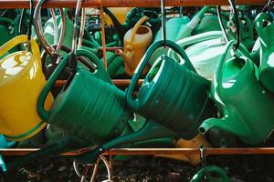 many green and yellow watering cans photo