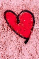 a red painted heart on a wall photo