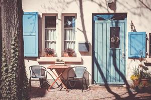 Garden furniture outside a house with blue door photo
