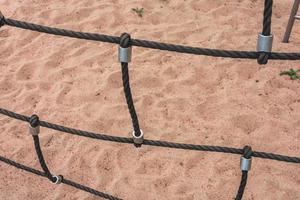 a climbing net over the sand on the beach photo