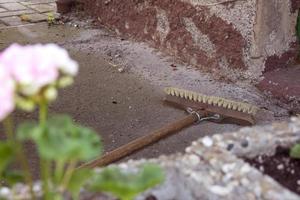 broom in front of an old house wall photo