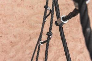 a climbing net over the sand on the beach photo