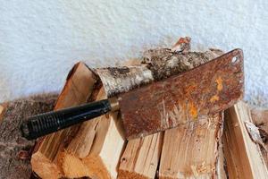 a old cleaver on a pile of wood photo