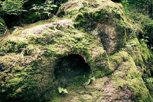 cave entrance in the mountains photo