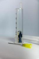 Grim Reaper figurine in a hypodermic syringe photo