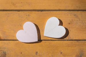 two hearts on a wooden table photo