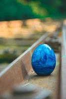 blue egg on a railway track photo