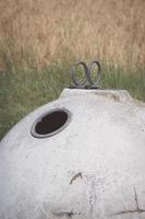 white glass container in front of a field photo