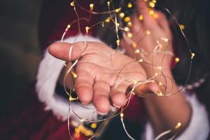 Led garland lights in girls hands photo